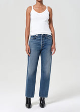 Load image into Gallery viewer, Agolde's best-selling 90's Jean in medium vintage indigo with subtle fading, marbling, and whiskering details. This decade inspired mid-rise is designed to sit relaxed at the waist with an easy fit through the hips into a classic, loose straight leg. Style back to anything and everything. Available at aprilmae - a womenswear boutique located in Chiswick west London specialising in contemporary, everyday clothing for women. Visit our shop on Devonshire Road W4 for the latest arrivals.