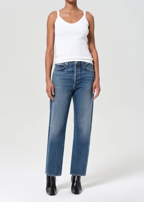 Agolde's best-selling 90's Jean in medium vintage indigo with subtle fading, marbling, and whiskering details. This decade inspired mid-rise is designed to sit relaxed at the waist with an easy fit through the hips into a classic, loose straight leg. Style back to anything and everything. Available at aprilmae - a womenswear boutique located in Chiswick west London specialising in contemporary, everyday clothing for women.  Visit our shop on Devonshire Road W4 for the latest arrivals.