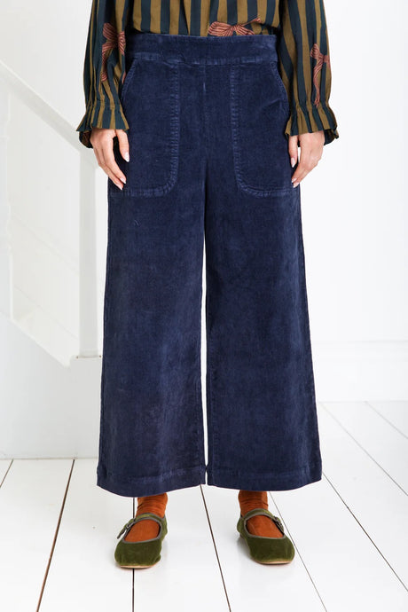 Bijou by Bonte is a loose + relaxed fitting, 3/4 length, wide-leg pull-on trouser, with an elasticated back, in a garment washed organic cotton bay-cord, in a versatile navy blue . Side seam pockets with stitch-through detail. Twin-needle stitching throughout. Available at aprilmae - a womenswear boutique located in Chiswick west London specialising in contemporary, everyday clothing for women.  Visit our shop on Devonshire Road W4 for the latest arrivals from brands including Rains, Rails and Bellerose.