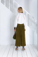 Load image into Gallery viewer, Bijou by Bonte is a loose + relaxed fitting, 3/4 length, wide-leg pull-on trouser, with an elasticated back, in a garment washed organic cotton bay-cord, in a versatile olive green. Side seam pockets with stitch-through detail. Twin-needle stitching throughout. Available at aprilmae - a womenswear boutique located in Chiswick west London specialising in contemporary, everyday clothing for women.  Visit our shop on Devonshire Road W4 for the latest arrivals from brands including Rains, Rails and Bellerose.
