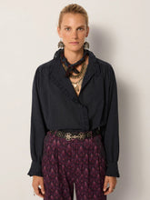 Load image into Gallery viewer, Celeste by Maison Hotel  is a soft viscose shirt with texture and lightness. The blue tone softens into a lived-in wash.  Ruffles trim the collar, placket, and cuffs, adding movement and a romantic edge. The relaxed fit makes it endlessly wearable.  Available at aprilmae - a womenswear boutique located in Chiswick west London specialising in contemporary, everyday clothing for women.  Visit our shop on Devonshire Road W4 for the latest arrivals from brands including Rains, Rails, Bellerose and Bonte.
