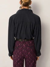 Load image into Gallery viewer, Celeste by Maison Hotel  is a soft viscose shirt with texture and lightness. The blue tone softens into a lived-in wash.  Ruffles trim the collar, placket, and cuffs, adding movement and a romantic edge. The relaxed fit makes it endlessly wearable.  Available at aprilmae - a womenswear boutique located in Chiswick west London specialising in contemporary, everyday clothing for women.  Visit our shop on Devonshire Road W4 for the latest arrivals from brands including Rains, Rails, Bellerose and Bonte.
