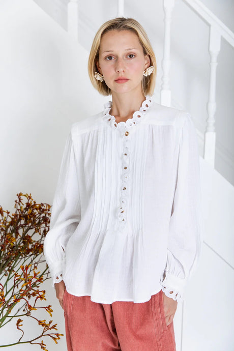 Etienne shirt by Bonte in white.  A relaxed + easy smock-style shirt in an organic cotton double-gauze, with detailed eyelet embroidery on the collar, placket and cuffs. The centre front has a concealed half-placket opening to the waist, with mock horn buttons + loop closure with, fine pleats on either side. Oversized fit. Available at aprilmae - a womenswear boutique located in Chiswick west London specialising in contemporary, everyday clothing for women.  Visit our shop on Devonshire Road W4.