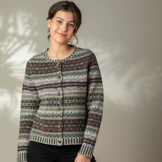 Woman wearing a patterned sweater against a neutral background westerly cardigan glance shetland wool aprilmae