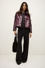 Load image into Gallery viewer, Meelos jacket in shiny Bordeaux from ba&amp;sh Woman wearing a shiny purple jacket and black pants on a white background aprilmae chiswick women&#39;s clothing
