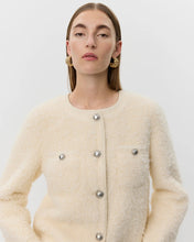 Load image into Gallery viewer, Woman wearing a cream-colored textured jacket with silver buttons on a white background Benedict jacket ecru off white aprilmae chiswick women fashion

