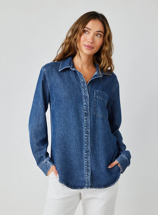 This Horizon Wash Pocket Button Down Shirt from Bella Dahl offers a modern twist on a classic button down. Made with soft and breathable lyocell fabric, it is perfect for denim-on-denim or paired with crisp white pants. Upgrade your wardrobe with this versatile and stylish piece. Available at aprilmae - a womenswear boutique located in Chiswick west London specialising in contemporary, everyday clothing for women.  Visit our shop on Devonshire Road W4 for the latest arrivals.