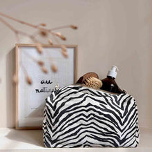 Load image into Gallery viewer, Zebra print toiletry pouch with a gold zipper on a white background from Rose in April. Available at aprilmae - a womenswear boutique located in Chiswick west London specialising in contemporary, everyday clothing for women.  Visit our shop on Devonshire Road W4 for the latest arrivals from brands including Rains, Rails, Bellerose, Bonte, Vanessa Bruno, Hartford and Colorful Standard.
