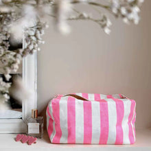Load image into Gallery viewer, Pink and white striped toiletry pouch on a surface with a mirror and flowers in the background by Rose in April. Available at aprilmae - a womenswear boutique located in Chiswick west London specialising in contemporary, everyday clothing for women.  Visit our shop on Devonshire Road W4 for the latest arrivals from brands including Rains, Rails, Bellerose, Bonte, Vanessa Bruno, Hartford and Colorful Standard.
