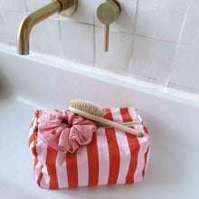 Load image into Gallery viewer, Red and white striped toiletry pouch with a scrubber and brush on a bathroom sink by Rose in April. Available at aprilmae - a womenswear boutique located in Chiswick west London specialising in contemporary, everyday clothing for women.  Visit our shop on Devonshire Road W4 for the latest arrivals from brands including Rains, Rails, Bellerose, Bonte, Vanessa Bruno, Hartford and Colorful Standard.
