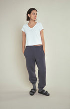Load image into Gallery viewer, The Sonoma white V-neck T-shirt from American Vintage looks great on its own or layered. It is made from a heavyweight authentic slub cotton and is soft and warm. Featuring raw edge detailing, the Sonoma has a laid-back vibe. Available at aprilmae - a womenswear boutique located in Chiswick west London specialising in contemporary, everyday clothing for women.  Visit our shop on Devonshire Road W4 for the latest arrivals from brands including Rains, Rails, Bellerose, Bonte, Vanessa Bruno and Hartford.
