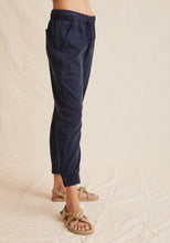 Load image into Gallery viewer, The Pocket Jogger from Bella Dahl is a new forever favourite. It has a relaxed feel to it and features a drawstring waist, large front pockets and elasticised cuffs. Shown in Endless Sea a dark blue. Available at aprilmae - a womenswear boutique located in Chiswick west London specialising in contemporary, everyday clothing for women.  Visit our shop on Devonshire Road W4 for the latest arrivals from brands including Rains, Rails, Bellerose, Bonte, Vanessa Bruno, Hartford and Colorful Standard.
