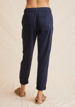 Load image into Gallery viewer, The Pocket Jogger from Bella Dahl is a new forever favourite. It has a relaxed feel to it and features a drawstring waist, large front pockets and elasticised cuffs. Shown in Endless Sea a dark blue. Available at aprilmae - a womenswear boutique located in Chiswick west London specialising in contemporary, everyday clothing for women.  Visit our shop on Devonshire Road W4 for the latest arrivals from brands including Rains, Rails, Bellerose, Bonte, Vanessa Bruno, Hartford and Colorful Standard.
